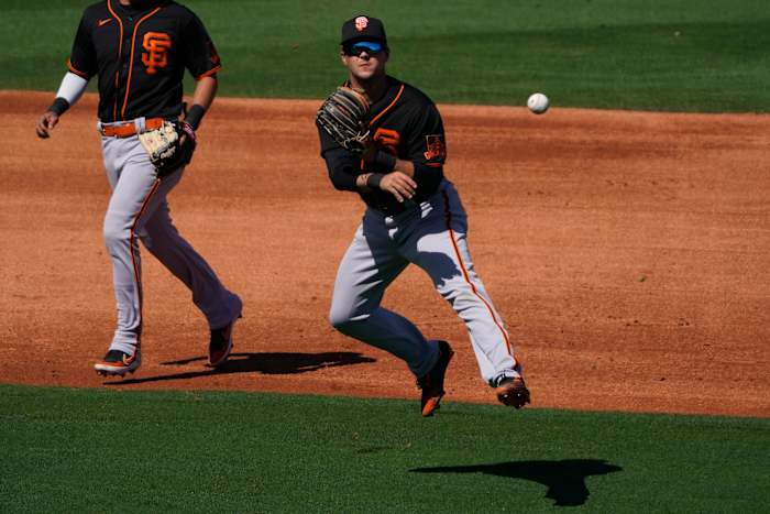 SF Giants third baseman Will Wilson makes the off balance throw for an out against the Los Angeles Angels during a spring training game at Tempe Diablo Stadium. (2021)